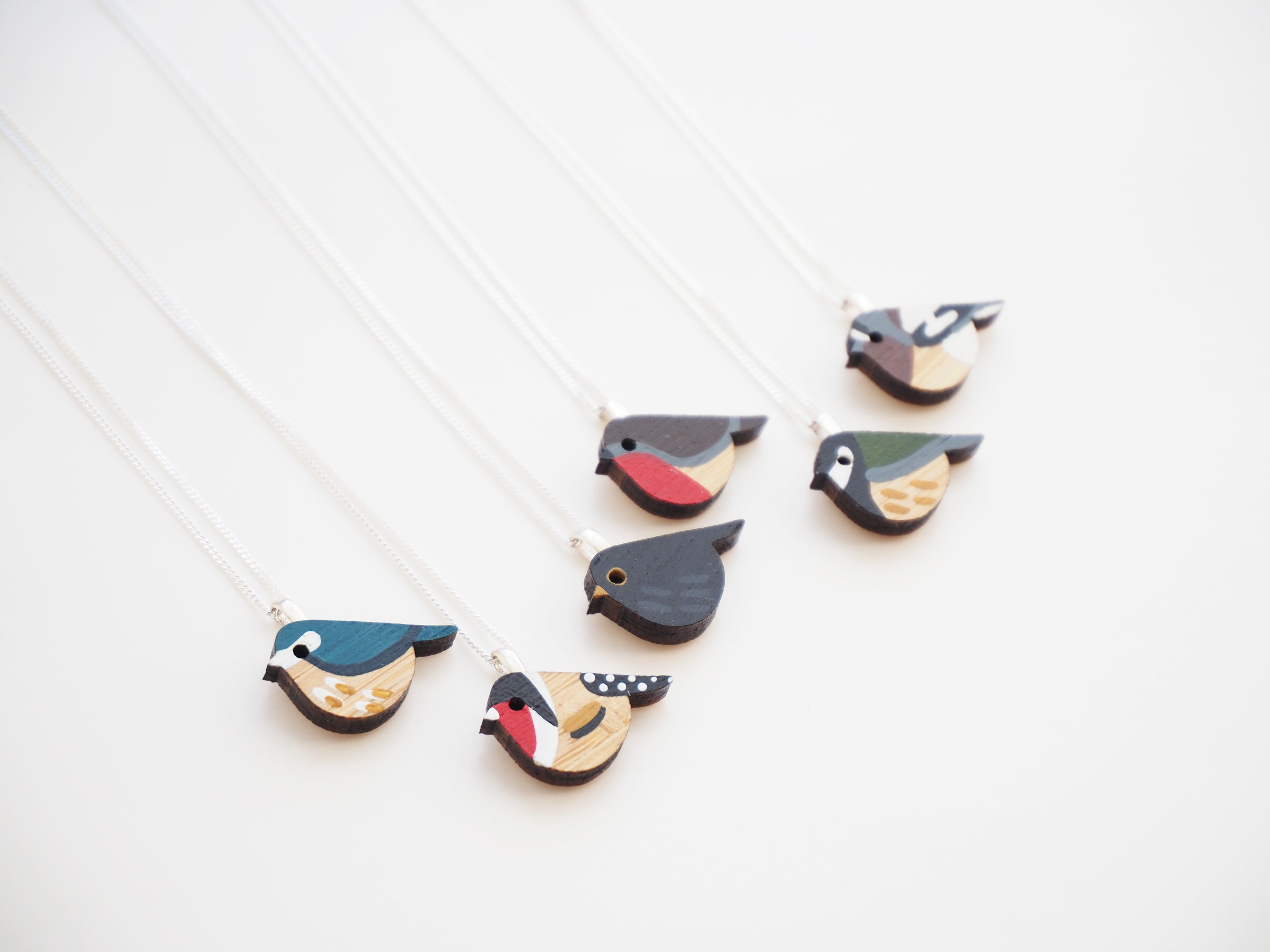 a collection of garden bird themed necklaces. Hand painted and laser cut from bamboo by the mountain and me.