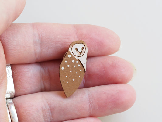 Hand-painted Mini Barn Owl Pin Badge held in hand, showcasing detailed design and cute features.
