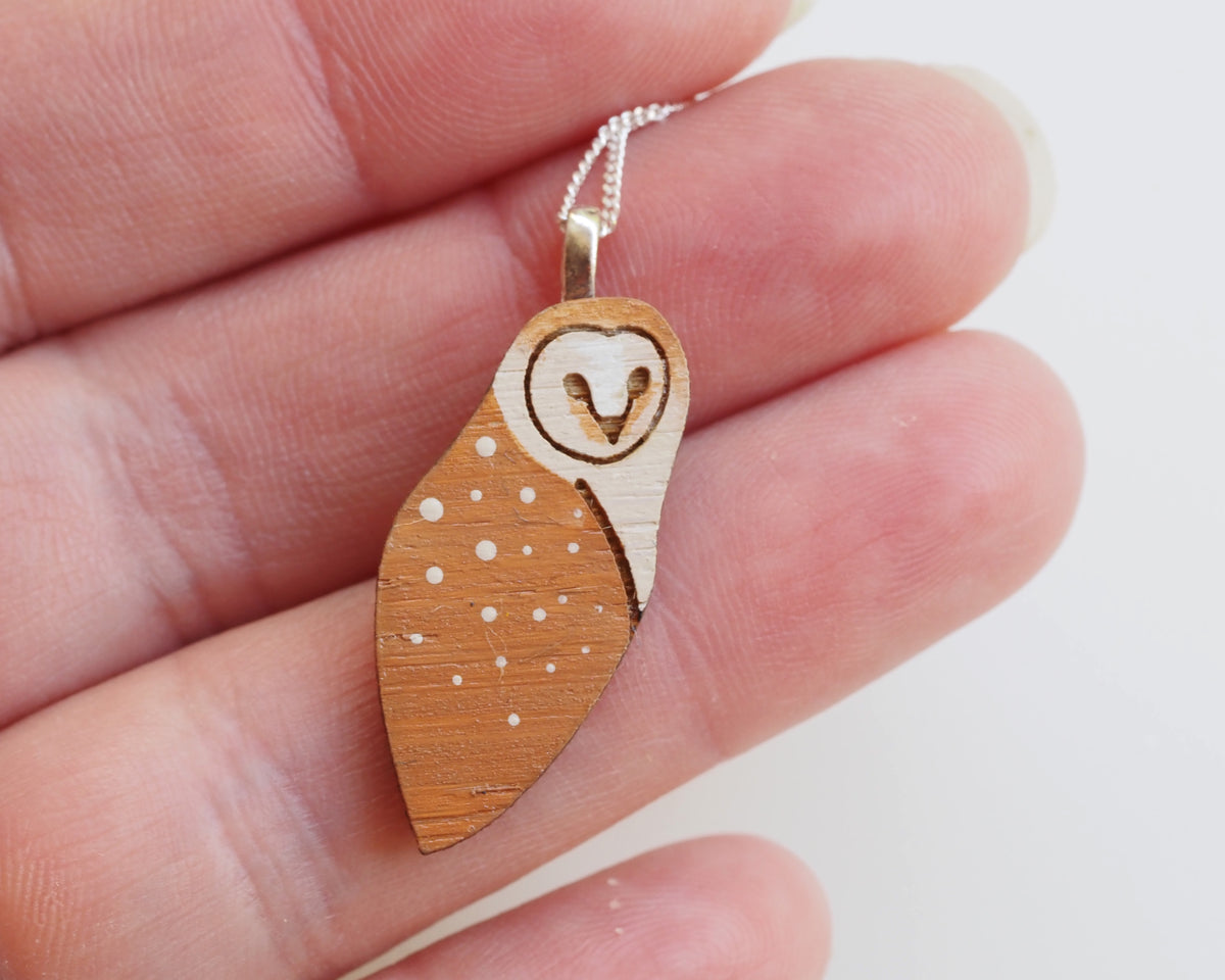 Barn Owl Necklace - Sterling Silver showcased in hand, featuring hand-painted details on sustainable bamboo.