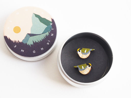 Goldcrest earrings in a tin, featuring hand painted bird studs inspired by British wildlife.