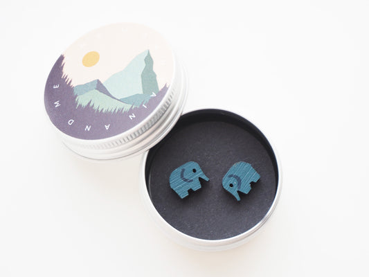 Hand Painted Wooden Elephant Stud Earrings in a decorative tin box, showcasing playful blue/grey elephants.