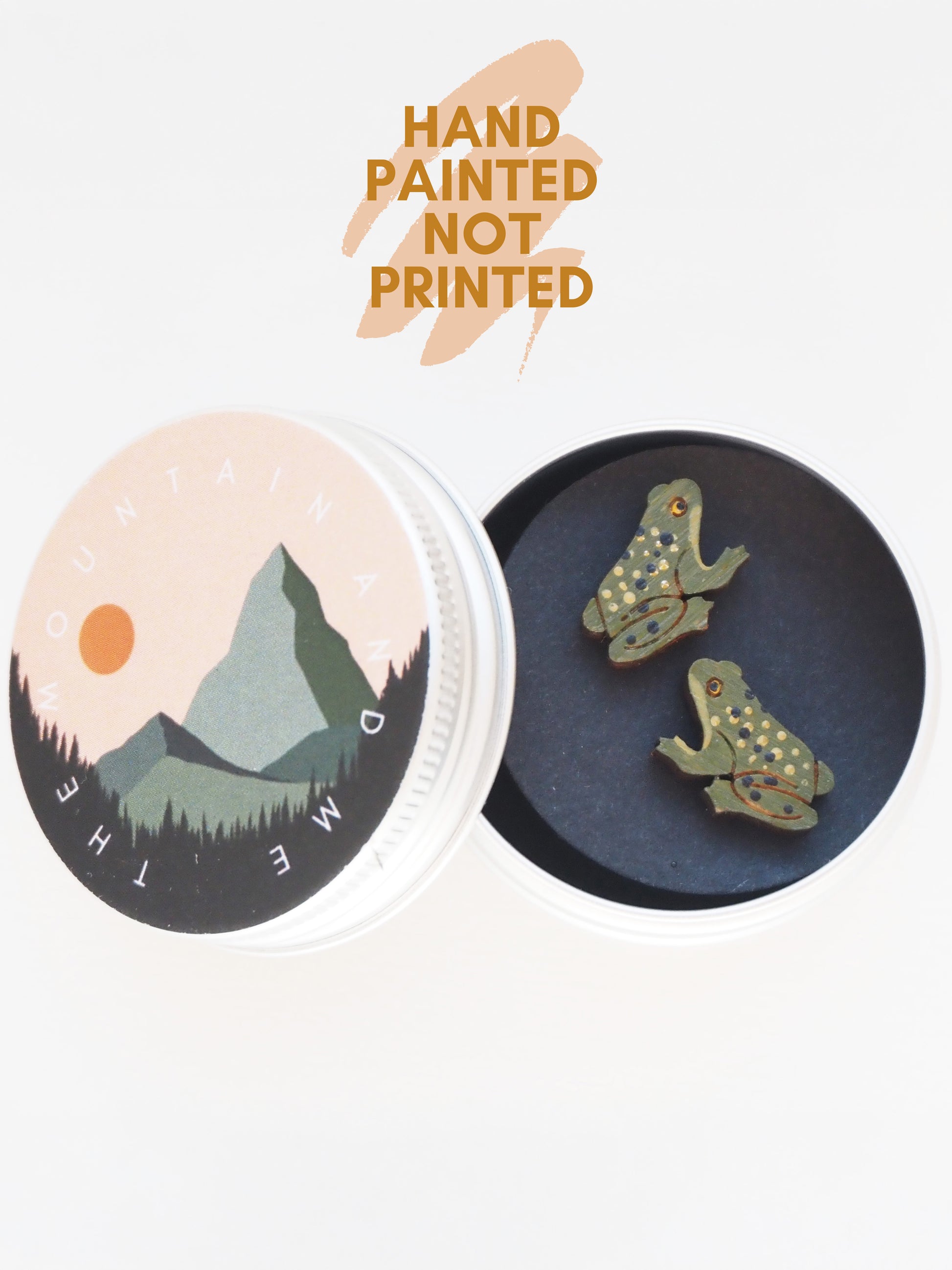 Hand Painted Frog Earrings displayed in a tin, showcasing their unique hand-painted design, not printed.