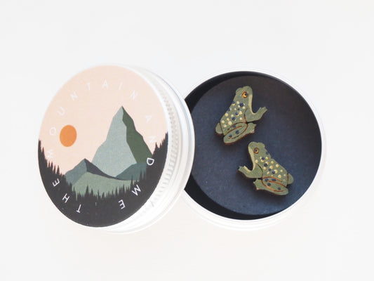 Hand Painted Frog Earrings displayed in a tin, featuring charming frog designs made from bamboo.